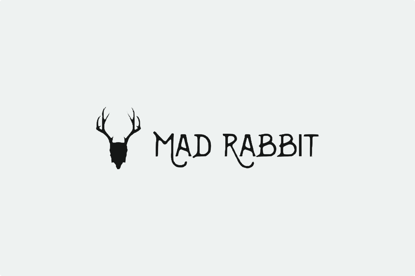 Logo with a silhouette of a rabbit head with antlers next to the text "MAD RABBIT" in stylized font.